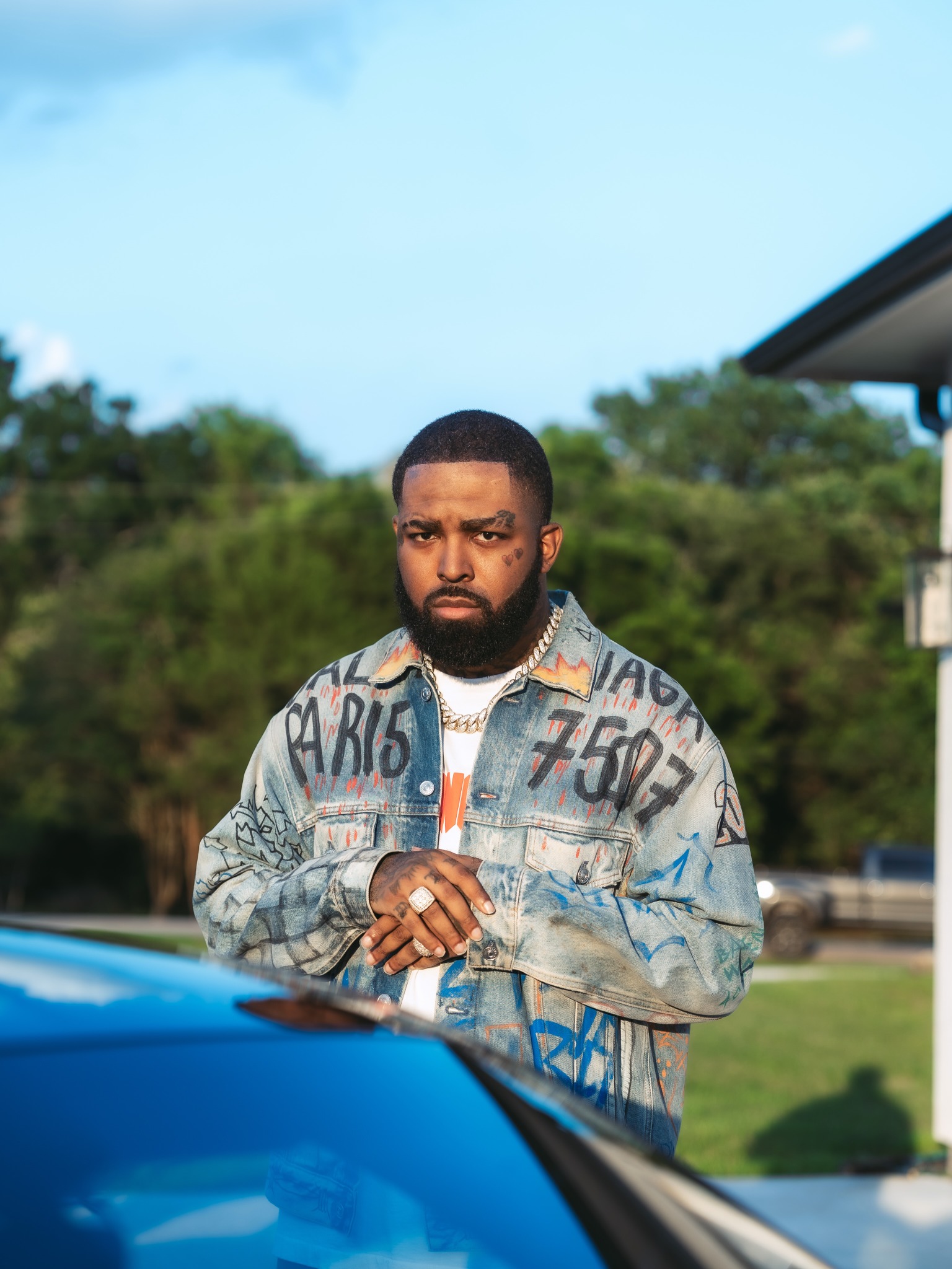 Brodie Fresh beside a blue sports car